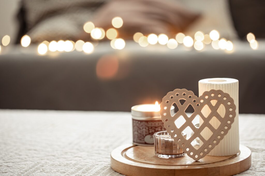 Cozy background for Valentine's Day with decorative heart and candles.